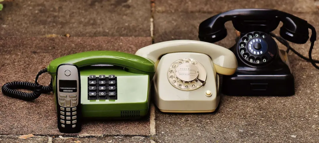 three old school landline telephones